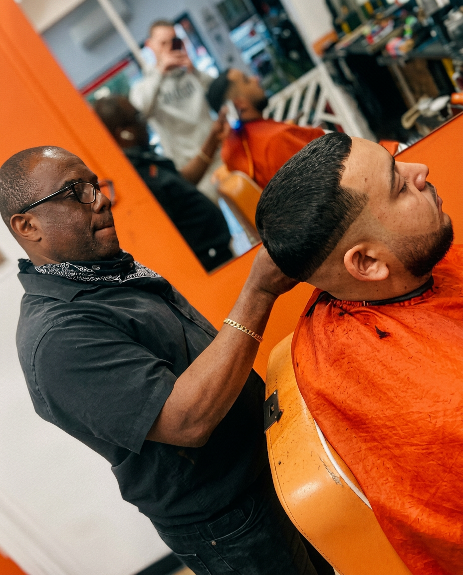 Barber working at the chair inside Extreme Kutz